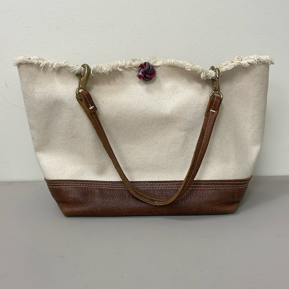 Durable waxed canvas handbag with leather handles and bottom